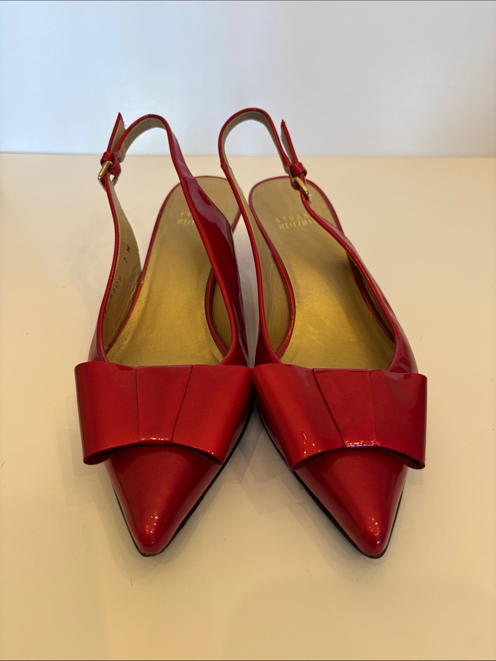Stuart Weitzman patent pointed toe kitten heel sling back with bow